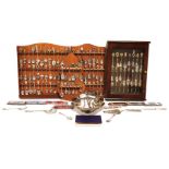 Large collection of souvenir spoons with display shelves in cabinets and assorted flatware, some odd