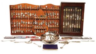 Large collection of souvenir spoons with display shelves in cabinets and assorted flatware, some odd