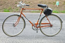 Raleigh gentleman's bicycle in orange finish, with saddle bag, head lamp and bell, and original