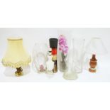 Two glass vases, one with a faux orchid, an ovoid-shaped vase with stars on the side, an alabaster