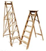 Two vintage stepladders, one distressed with paint splashes (199cm and 155cm) (2)
