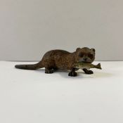 Austrian cold painted bronze model of an otter holding a fish in its mouth, 10cm long approx.