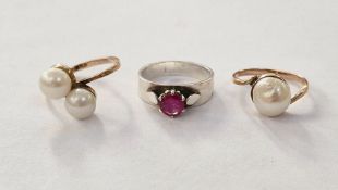 Two gold-coloured rings set with pearls and a silver-coloured ring set with garnet-coloured stone (