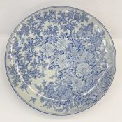 Japanese blue and white porcelain charger painted in underglaze blue with allover peonies,