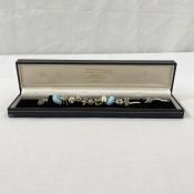 Silver charm bracelet with Pandora-type silver and enamel and ceramic charms