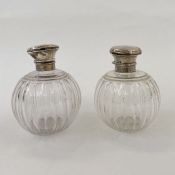 Pair of early 20th century silver lidded and glass globular scent bottles (dented and damage to