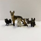 Cold painted bronze models of various dogs:- a standing German Shepherd, 6cm high, a sitting