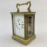 Brass carriage clock, the scroll and bar handle inscribed 'Simmons, Cheltenham', with striking