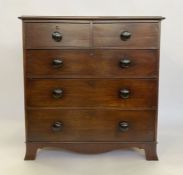 Victorian mahogany chest of two short and three long graduated drawers, with bun handles, on bracket