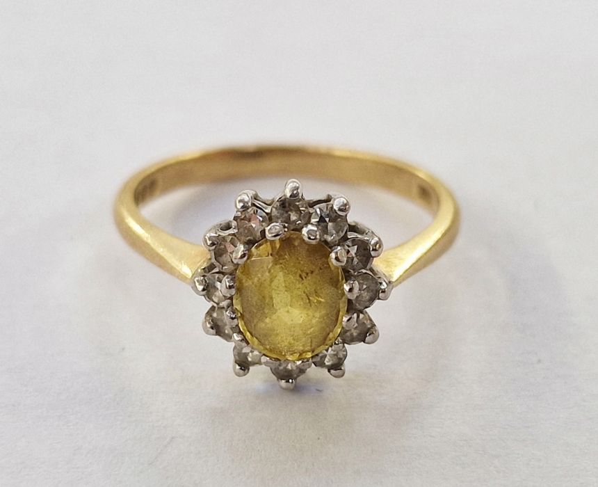 18ct gold, yellow stone and diamond cluster ring, the oval yellow stone surrounded by smaller