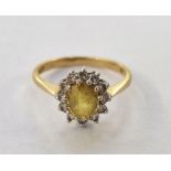 18ct gold, yellow stone and diamond cluster ring, the oval yellow stone surrounded by smaller