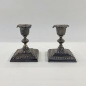 A pair of Victorian silver mounted squat candle sticks, shaped on square stepped base, Sheffield