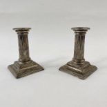 Pair of Victorian silver dwarf candlesticks, each with stop-fluted column, on square stepped