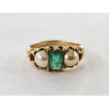 Gold, emerald and pearl ring set centre baguette-cut emerald flanked by pair half pearls