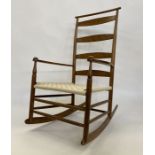 Shaker-style stained wood curved ladderback rocking open armchair with woven plaited seat, turned