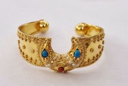 Indian gold bangle set with turquoise, red and seed pearls, gold relief decoration to the bangle,
