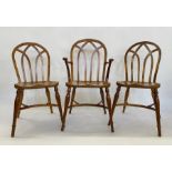 Set of eight Stewart Linford yew Gothic-style Windsor dining chairs viz:- six standards and two
