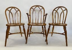 Set of eight Stewart Linford yew Gothic-style Windsor dining chairs viz:- six standards and two