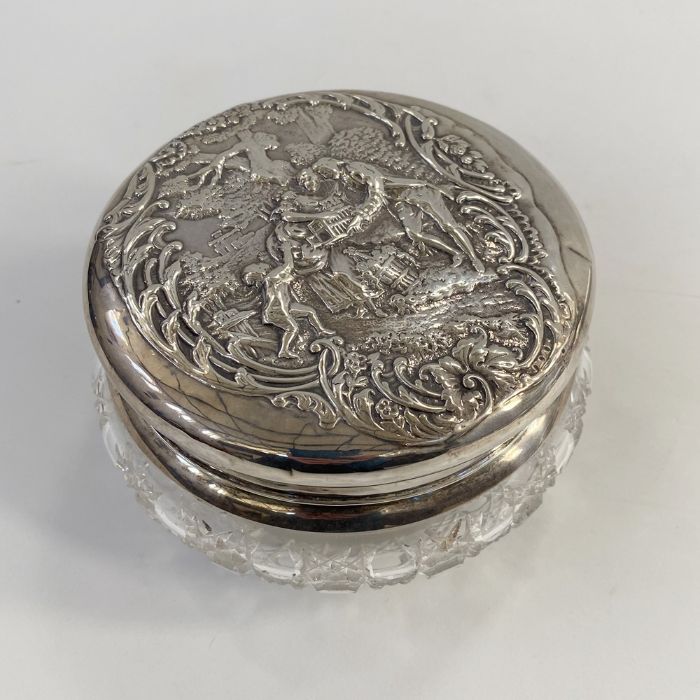 Edwardian silver lidded cut glass powder bowl, repousse decorated of a couple with child amongst - Image 2 of 4