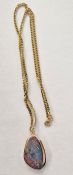 Gold-coloured and black opal/opal doublet pendant, shaped oval on 9ct flattened curb-link chain,