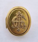 Victorian gold-coloured oval locket/brooch, relief initialled to front, 4cm x 3cm approx.