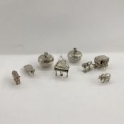 Quantity of white metal decorative objects: horse and coach, elephants, rhinoceros, a praying mantis