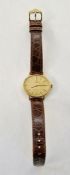 Lady's Omega gilt wristwatch, oval with champagne face, on leather strap