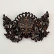 Chinese carved hardwood wall mask in the form of a grotesque Qilin, having carved feather and