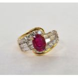 Gold metal, ruby and diamond set ring, set oval ruby, flanked by 12 baguette diamonds and twelve