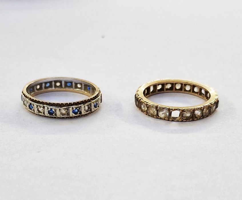 Gold-coloured metal eternity ring set white stones and another gold and silver-coloured metal ring