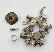 Silver charm bracelet to include elephant and whale charms, a Celtic metal brooch and a gold-