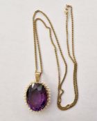 Gold-coloured pendant set with oval amethyst surrounded by seed pearls (unmarked), on 9ct gold