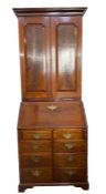 George III mahogany bureau bookcase, the top section with cavetto frieze, three adjustable
