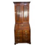 George III mahogany bureau bookcase, the top section with cavetto frieze, three adjustable