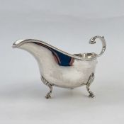 Victorian silver sauceboat with free C-scroll handle, beaded edge, on shell and pad feet, Birmingham