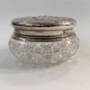 Edwardian silver lidded cut glass powder bowl, repousse decorated of a couple with child amongst