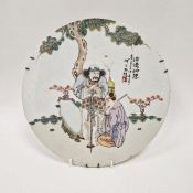 Chinese porcelain plaque, circular and painted with old man leaning on a gnarled peach stick with