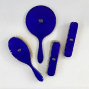 1930's silver and blue enamel four piece dressing set, three brushes and a mirror blue enamel with
