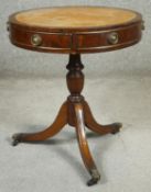 A Georgian style mahogany drum table with inset tooled leather top. H.56 D.50cm