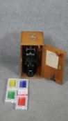 A vintage wooden cased W R Prior London microscope, model number 13377. With prepared slides and