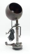 An industrial table lamp in the form of a seated figure with shade for the head. H.45cm