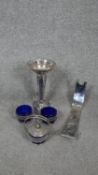 A collection of silver plate. Including a hammered abstract design wine bottle holder, a trumpet