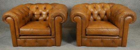 A pair of deep buttoned leather upholstered Chesterfield armchairs. H.65cm