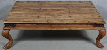 An Indian teak, metal bound and studded low table on cabriole supports. H.40 W.135 D.90cm