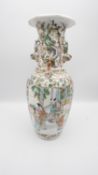 A Chinese hand painted porcelain vase with Foo dog handles and decorated with figures, blossom and