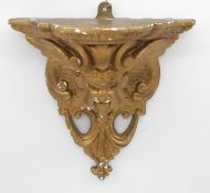A gilded plaster wall mounted sconce with gargoyle motif. H.33cm
