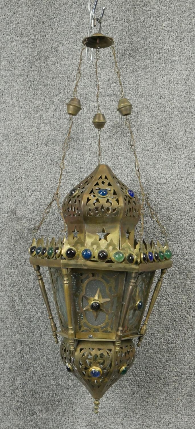 A pierced brass hanging lantern of North African influence. D.25cm