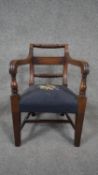 An early 19th century mahogany child's armchair with ropetwist back and stuffover tapestry