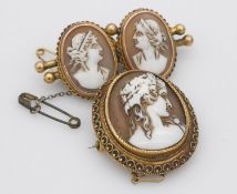 Two yellow metal cameo brooches. One oval with a side profile of Dionysus with filigree Etruscan