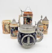 A collection German salt glaze steins in various sizes along with a Crown Ducal Harmony Guinness